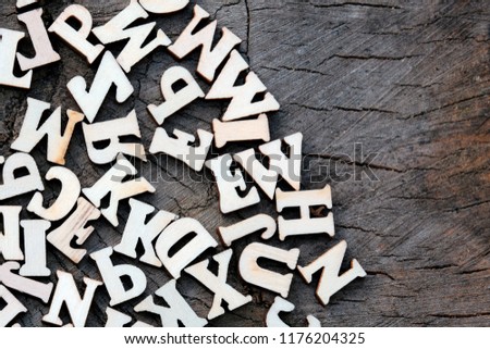 Abstract background of letters on an old wooden texture. Copy space for design.