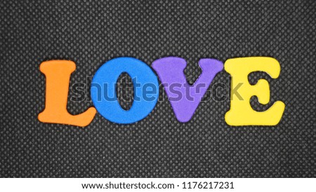 Orange Blue Purple and Yellow characters with the word love