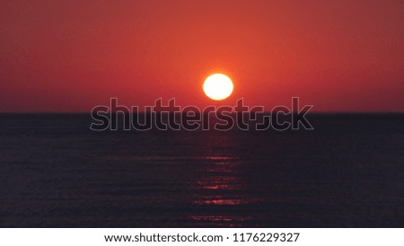 Red Sunset On the Water Sea in a Hot Summer Day