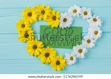Yellow and white heart flowers composition. Good morning wish surprise. Blue wood background.