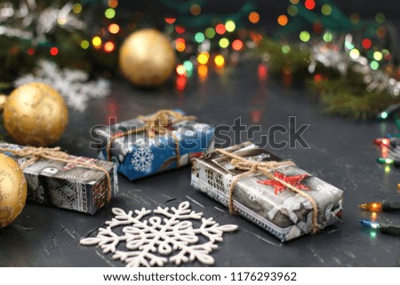 Christmas boxes, snowflakes and balls on dark background. Merry christmas greeting card. Winter xmas holiday theme. Happy New Year. Twinkle glitter bokeh light.