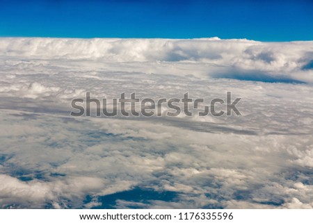 Bright sky blue background aerial view frome above from airplane. Sky in daylight with beautiful white cloud.