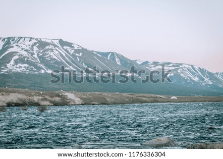 Amazing mountain landscape. mountain like flowing between high snow-capped mountains. 