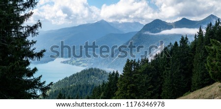 Beautiful mountain panorama with lake and forest and clouds