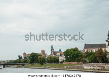The river flows through the city. Church on the hill above the river. Wisla River in Krakow. Float the boat and the ship under water
