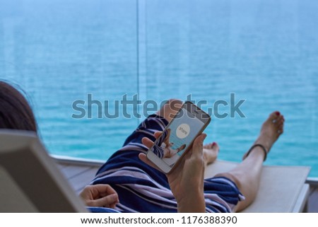 woman relaxing on a deck chair sharing a photo