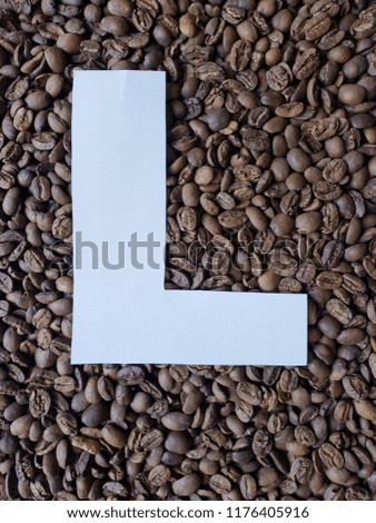 letter L in white and background with roasted coffee beans 