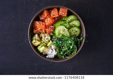 poke bowl with salmon over dark background. top view Royalty-Free Stock Photo #1176408118