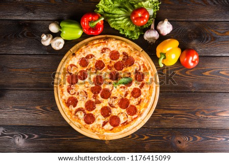 Pizza with salami, peperoni Royalty-Free Stock Photo #1176415099