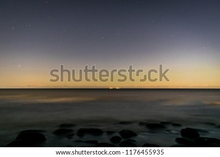 the beach and sea and rocks at night