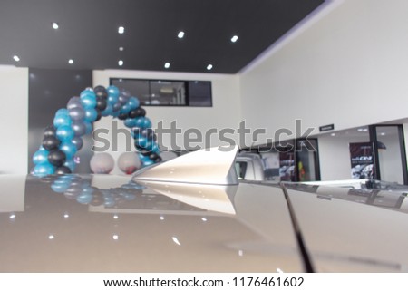 antenna shark fin silver color on roof in office blurry
background and balloon at party or festival.for automotive, transport
automobile image