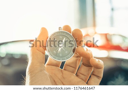 holding compass on blurred background. Using wallpaper or background
travel or navigator image.