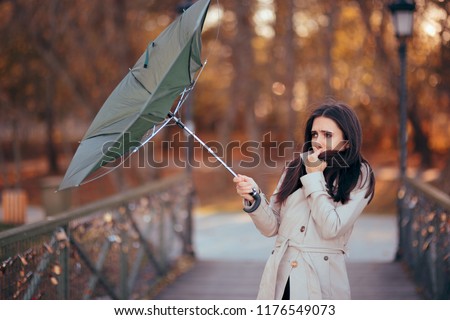 Girl Fighting The Wind Holding Umbrella Raining Weather. Autumn woman having problems in windy storm
 Royalty-Free Stock Photo #1176549073