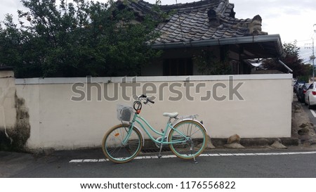 a bicycle leaning against the wall of a tile
