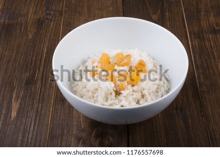 Rice porridge with rasins served in a white bowl