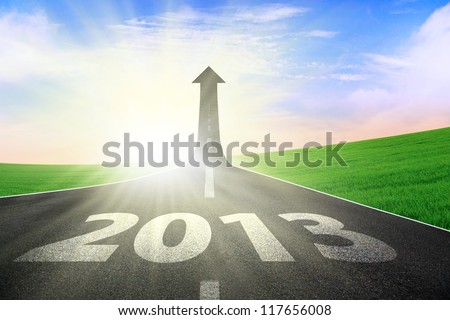 A road turning into an arrow rising upward with a road sign of success, symbolizing the direction to success in the year 2013 Royalty-Free Stock Photo #117656008