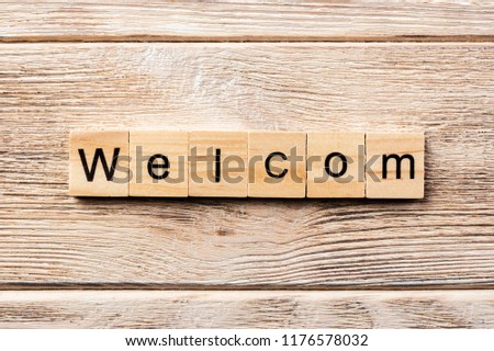 welcom word written on wood block. welcom text on table, concept.
