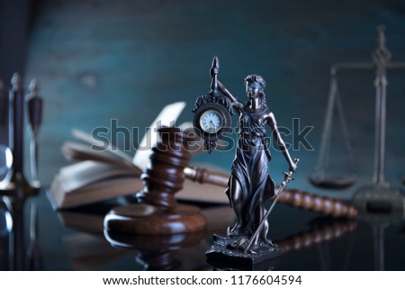 Law concept. Judge's gavel, statue of justice, scales, books, clock. Place for typography.