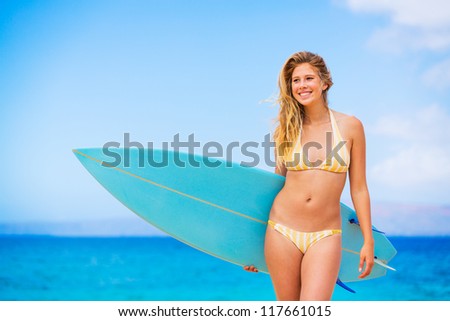 Beautiful Young Woman Surfer Girl in Bikini with Surfboard at a Beach