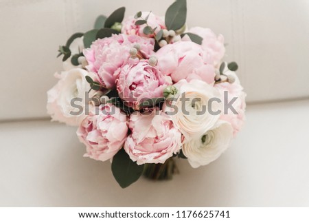 Beautiful wedding bouquet for the bride with pink peonies and white peony roses