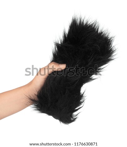 Hand holding Fluffy Windshield for Microphone Camcorder Recorder isolated on white background