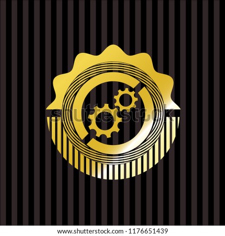 gear, team work icon inside gold badge or emblem