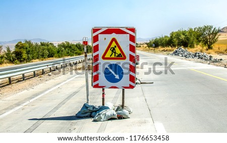 Road signs on a repaired road section