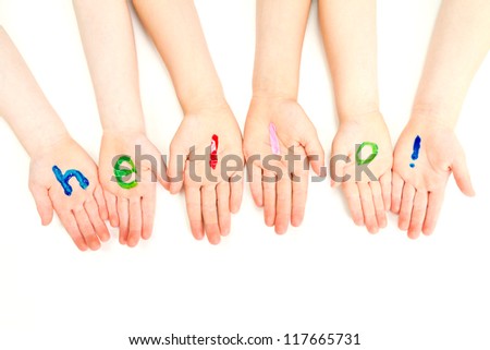 Kids hands with come in welcome painted on them. On white.