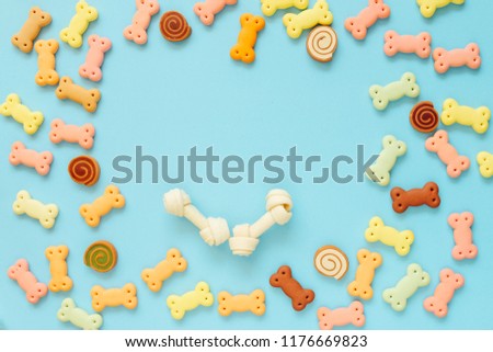 Dog biscuits, dog snack or dog treats in copy space in center on color background, Can use for background, Advertising product food or pet food. Royalty-Free Stock Photo #1176669823