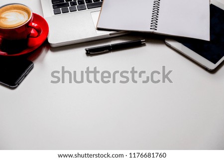 Laptop, office supplies, smartphone, notepad and coffee cup on white background.