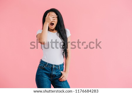 shocked african american woman covering eyes isolated on pink 