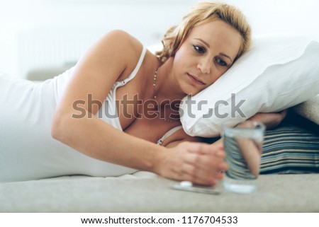 Picture of pregnant woman taking medication pills
