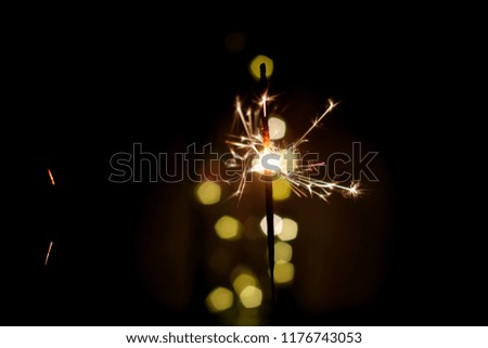 Beautiful Abstract blurred sparklers for celebration christmas and happy new year party background,Motion Blurred by wind Sparklers with Pentagon bokeh background, Dream Dark vintage film filter style