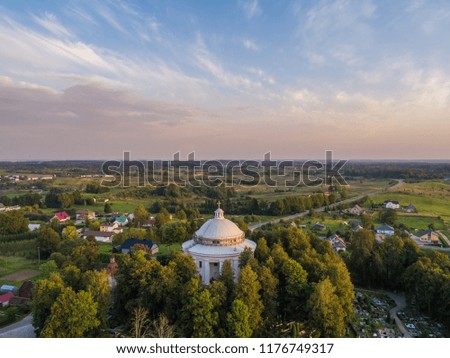 Aerial evening view of circular plan Holy Trinity Church in Suderve, Vilnius district, Lithuania