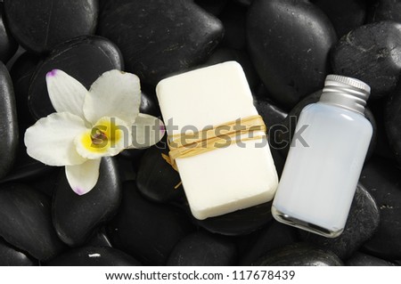 White orchid and massage oil ,soap on zen stones background