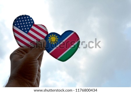 Hand holds a heart Shape USA and Namibia flag, love between two countries
