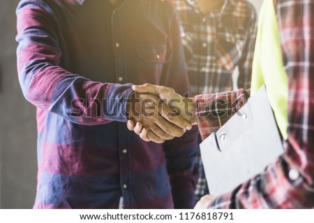 construction worker and contractor. Client shaking hands with team builder in renovation site. Royalty-Free Stock Photo #1176818791