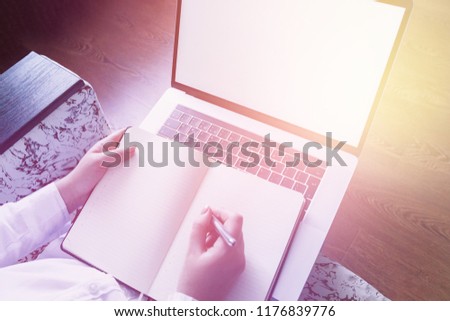 Side view. girl, businesswoman, working on laptop, notebook. Empty computer screen. A place for a logo, text. On-line market, education, e-learning.