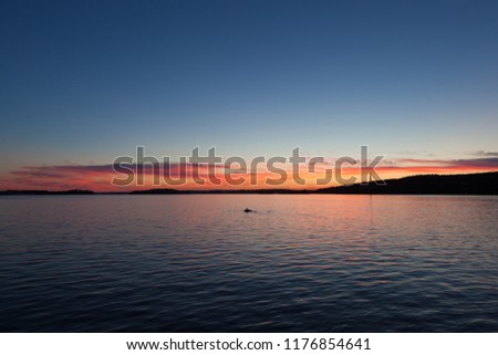 Calm sunset and clouds over lake in finland