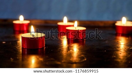  Soft Lighted Candles in a Catholic Church