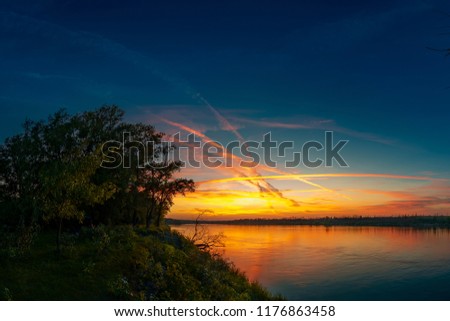 Sunset with traces of aircraft in the natural park "Donskoy". Volgograd region. Russia