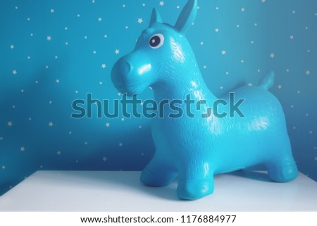 blue toy horse on the white table