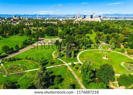 City Park in Denver , Colorado , USA Aerial drone view above City Park circle patterns modern designs with green grass and large trees Rocky Mountain background