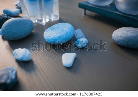 Nice two-colored picture with bright blue things in it - semi-transparent candlesticks and light-blue stones from the sea and mountains. Beautiful contrast. 