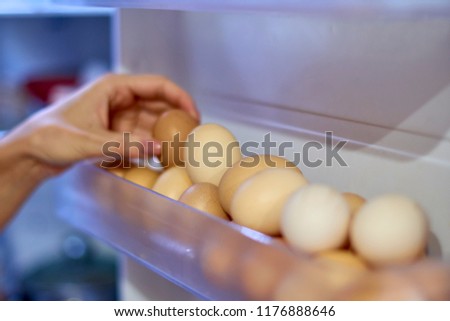 chicken eggs on a shelf of the refrigerator