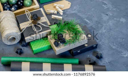 Packing of new kraft paper of the New Year and Christmas gift, green and black. Material for decorating the holiday. Natural decor in the style of eco-style.