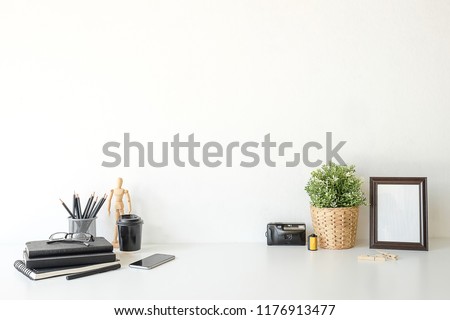 Mockup workspace desk and copy space books,plant and coffee on white desk. Royalty-Free Stock Photo #1176913477