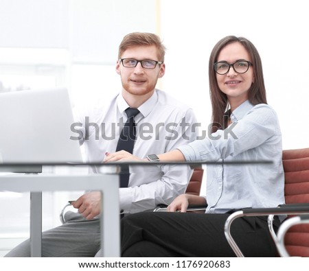 two employees sitting at the Desk in the office.photo with copy space