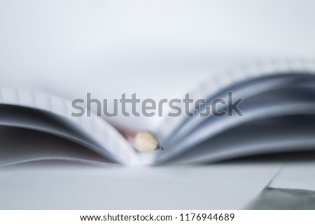 a pencil lying on the notebook