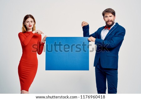 business man and woman in a red dress is holding a blue sheet of paper mock-up, poster                         